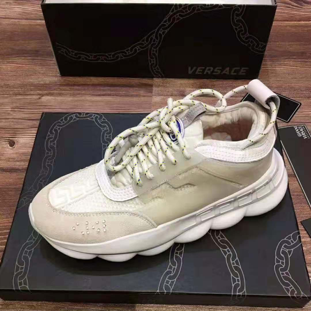 Close-up on gold Medusa hardware on Versace Men Chain Reaction Sneakers-White