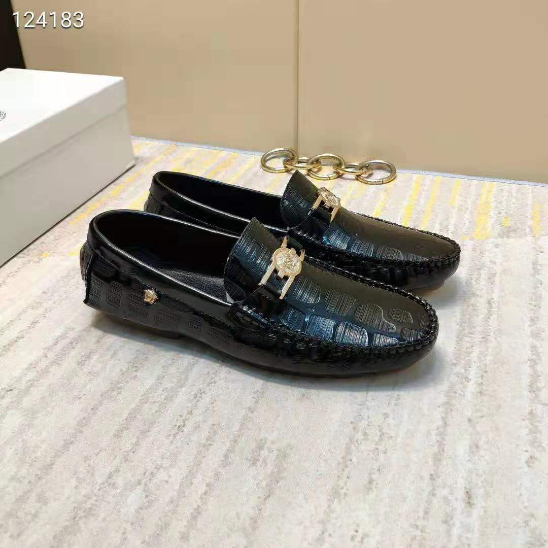Close-up of embossed Greca pattern on Versace driver shoes black