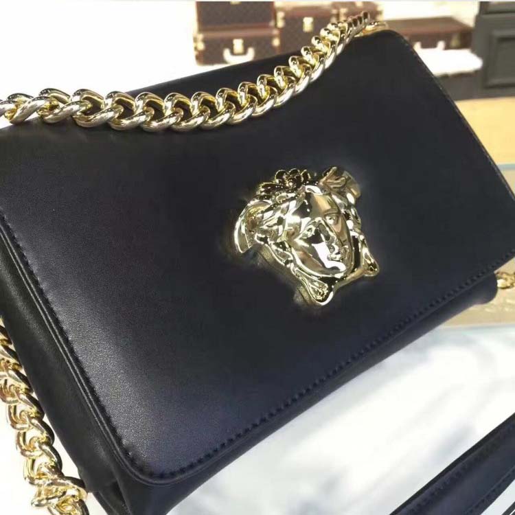 Close-up of gold Medusa hardware on Versace Palazzo Cross-Body Bag