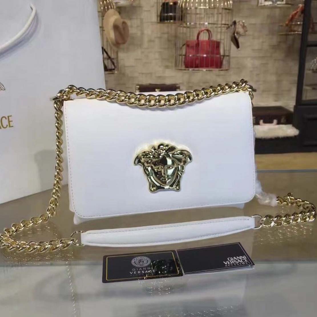 Close-up of gold Medusa emblem on Versace Palazzo Cross-Body Bag