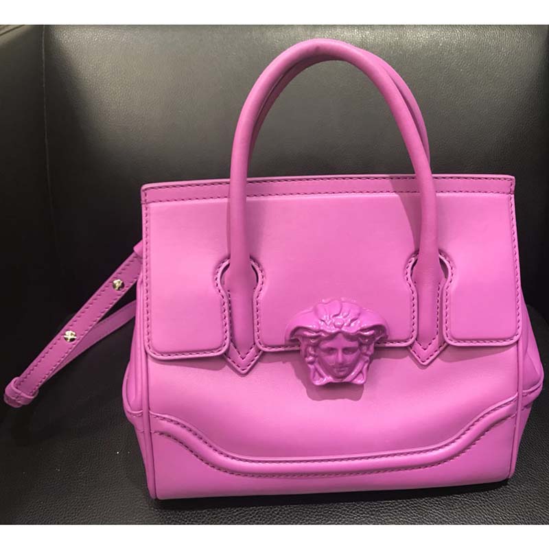 Close-up of gold Medusa head hardware on Versace Palazzo Empire bag