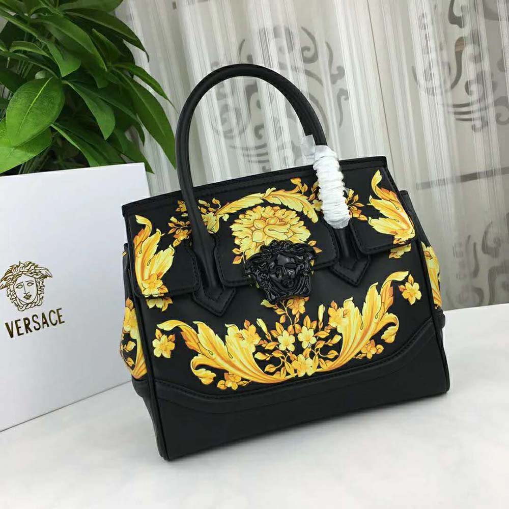 Close-up of embossed Barocco print and gold hardware on Versace women’s bag