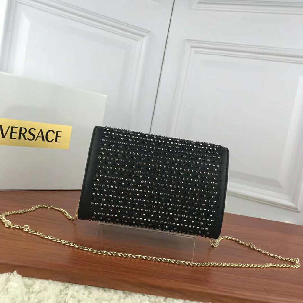 Side angle showing sleek black leather and adjustable strap on Versace Women Crystal Palazzo Evening Bag-Black