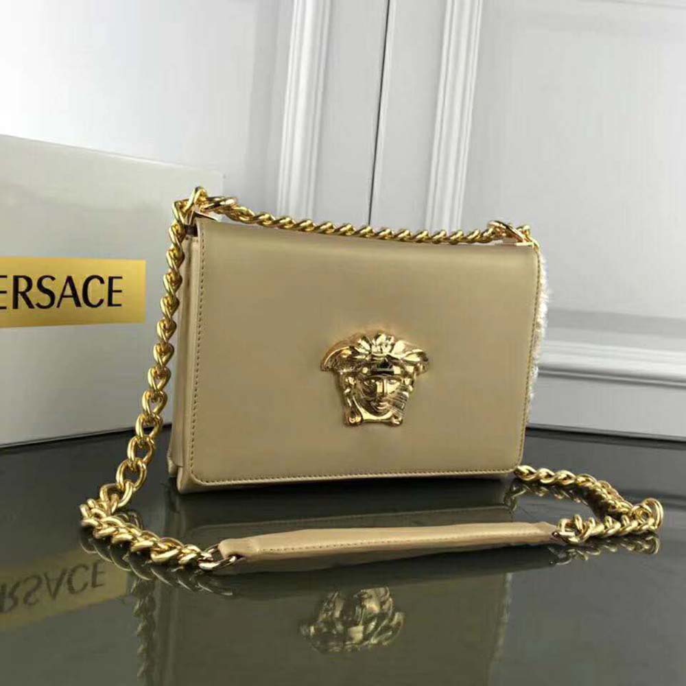 Close-up of gold Medusa hardware on Versace Women Laminated Palazzo Evening Bag
