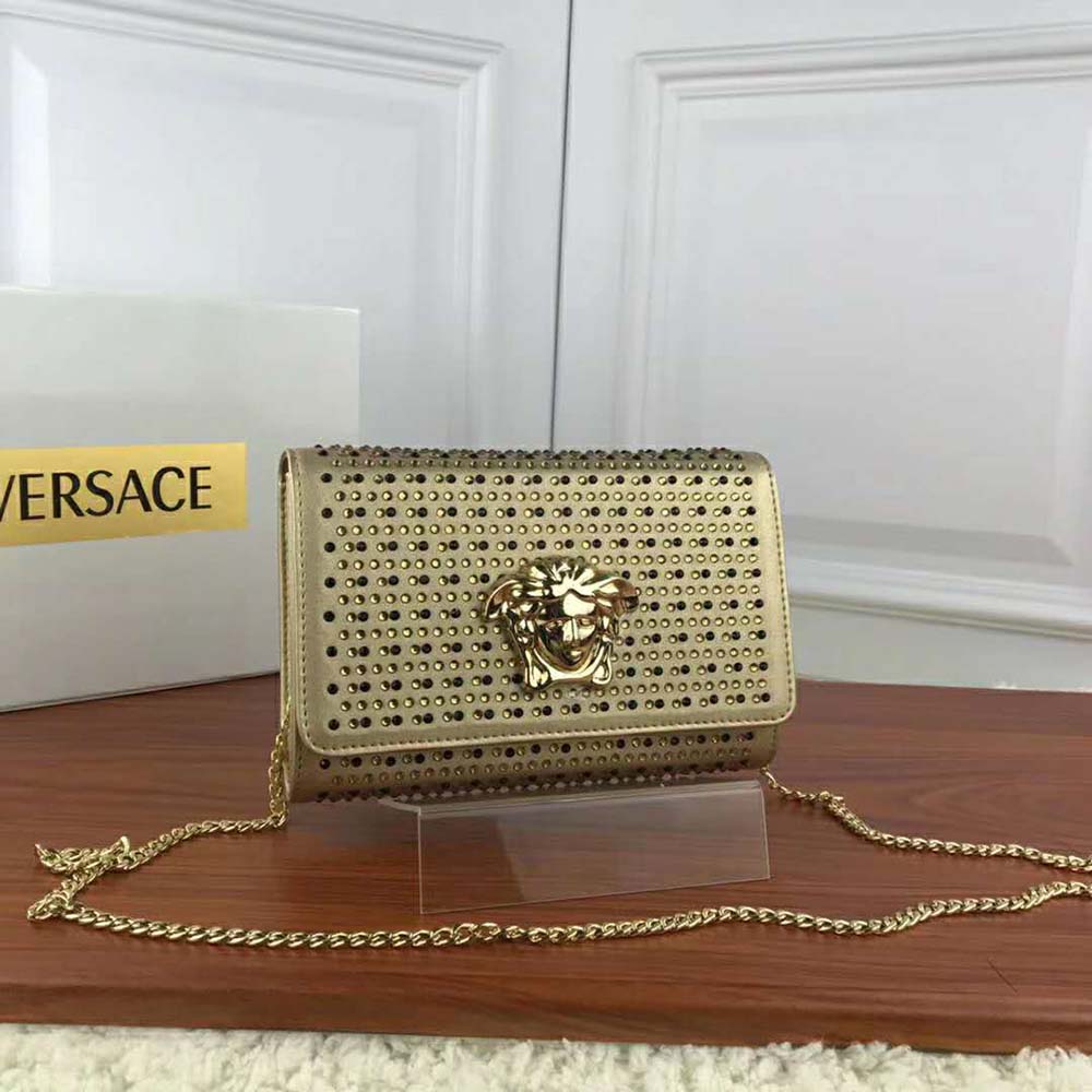 Close-up of gold Medusa hardware on Versace Women Laminated Palazzo Evening Bag-Gold
