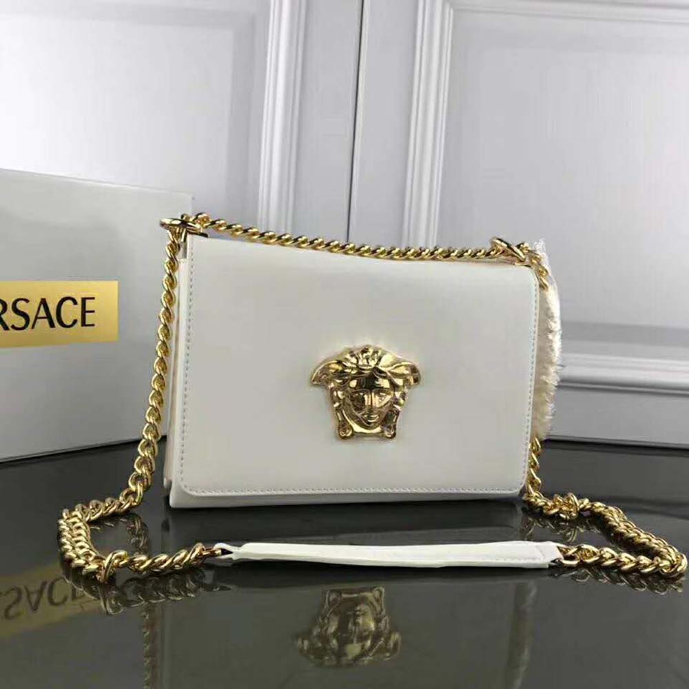 Side angle showing slim profile of Versace Women Medusa Head Evening Clutch Bag-White