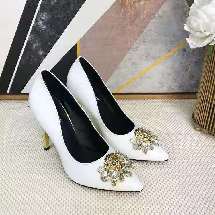 Close-up of gold Medusa emblem on Versace Women Palazzo Pumps White heel