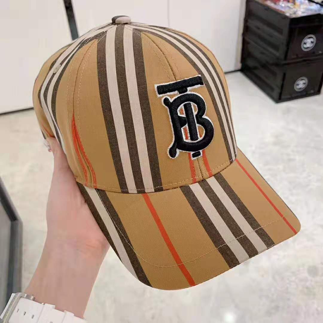 Close-up on brass buckle closure of Burberry Unisex Icon Stripe Baseball Cap-Brown