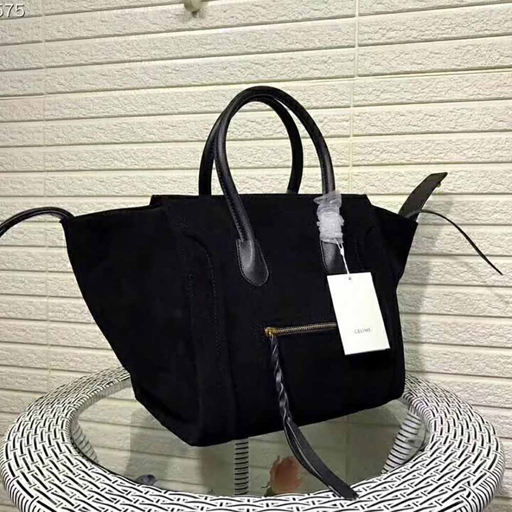 Side angle showing winged silhouette of Celine Medium Luggage Phantom Bag