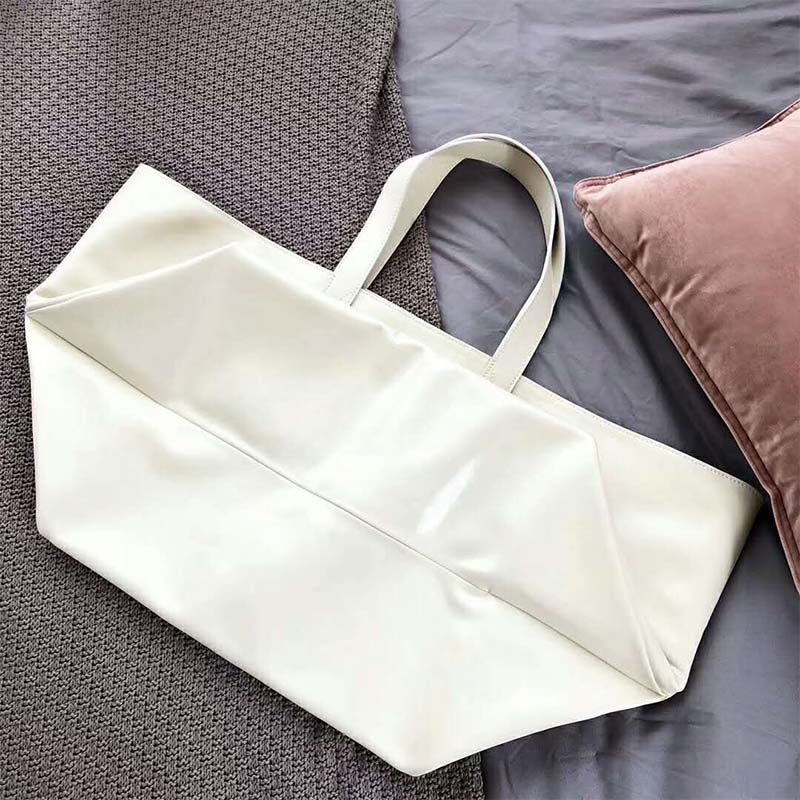 Side angle showing structured silhouette of Celine Women Medium Made in Tote in Leather-White