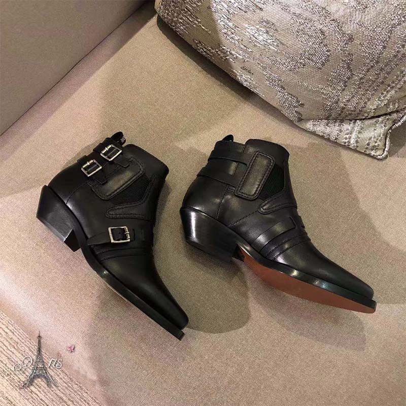Close-up of black calfskin leather and saddle detail on Dior ankle boot