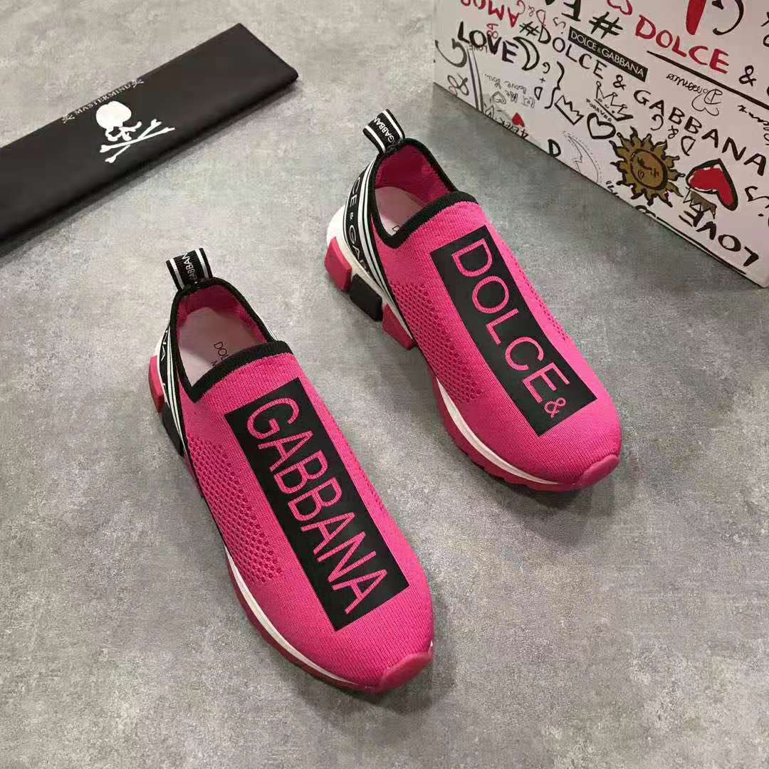 Close-up of rose leather and D&G logo hardware on sneakers