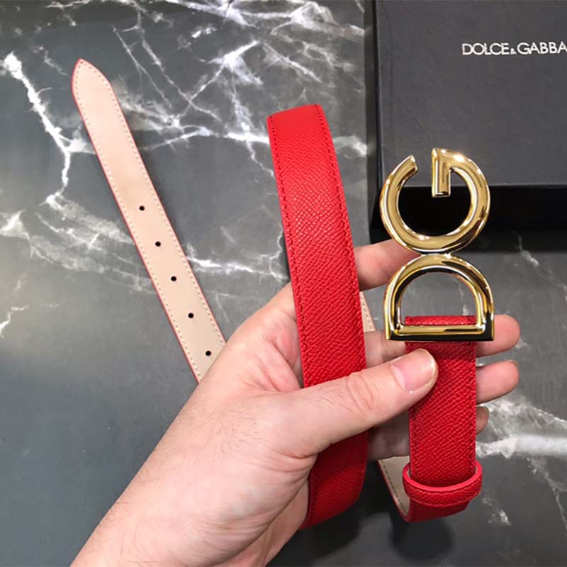 Close-up detail of red calfskin and D&G logo hardware on belt