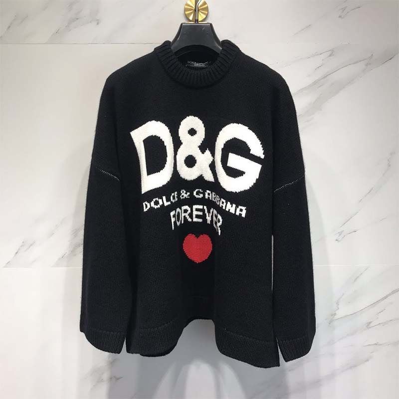 Close-up of cashmere texture and D&G logo on black knit sweater