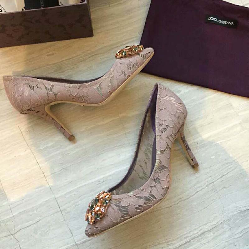 Close-up of sparkling crystal embellishments on pink lace pumps by Dolce Gabbana