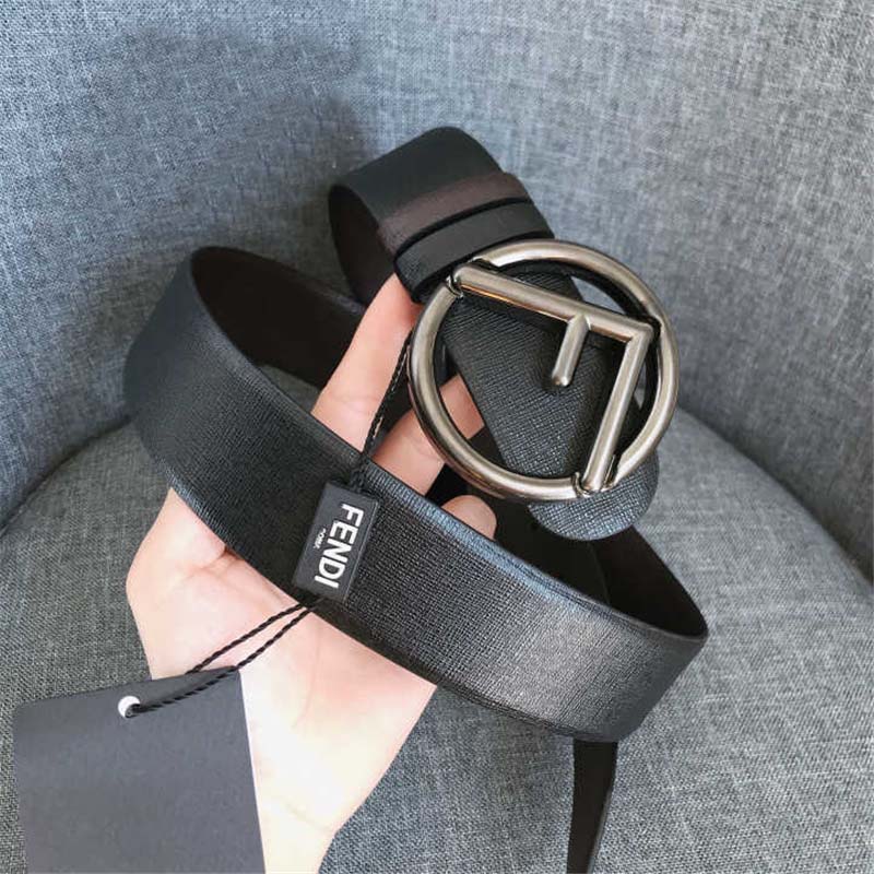 Close-up of Fendi logo hardware on black and brown leather belt