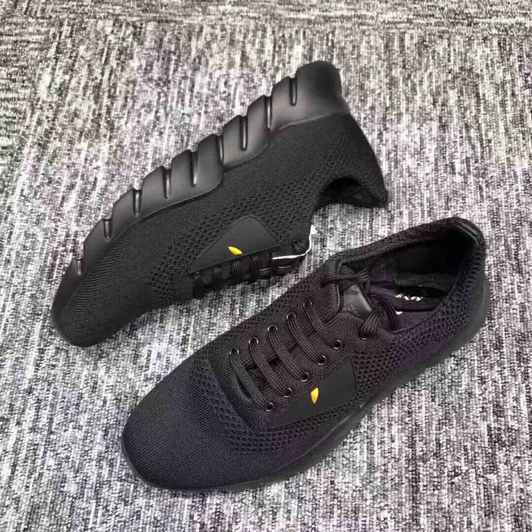 Close-up of black textile upper and Fendi logo hardware on running shoes