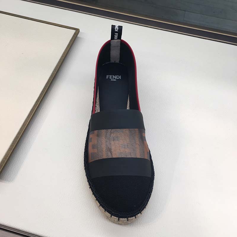 Close-up of embossed Fendi logo hardware on espadrilles in black canvas