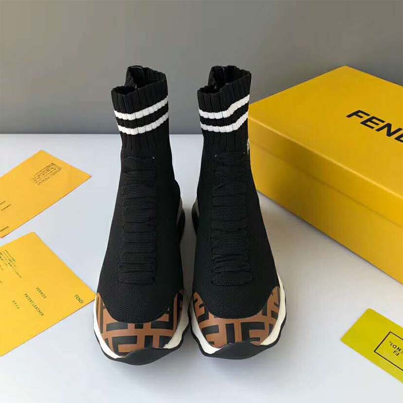 Close-up on Fendi logo detail on black fabric sneaker boots