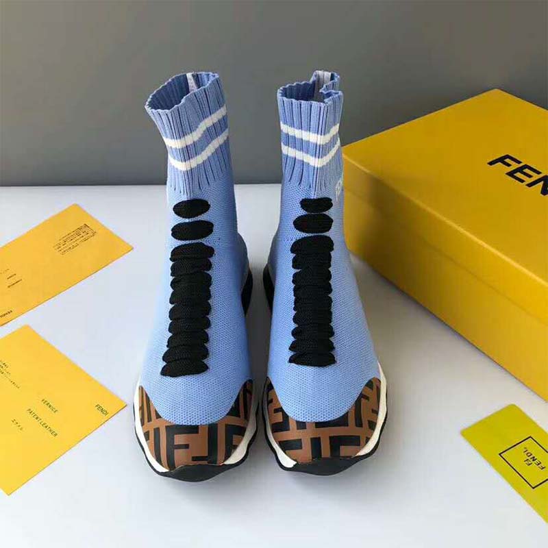 Close-up of blue lace-up and Fendi logo on sneaker boots