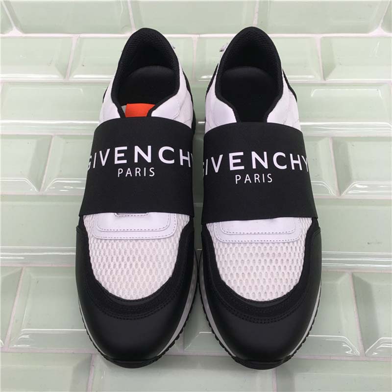 Close-up of Givenchy branding on black leather runner sneakers