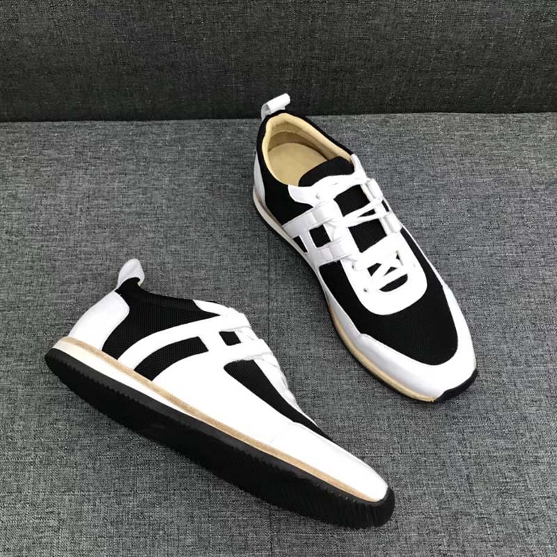 Close-up of Hermes Men Partner Sneaker Shoes Black embossed hardware detail