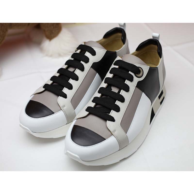 Close-up of embossed Hermes logo hardware on Men Rebus Sneaker Shoes White