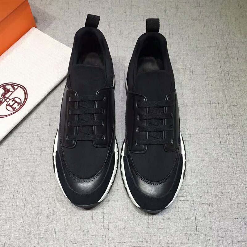 Close-up of black calf leather and embossed Hermes logo on sneaker