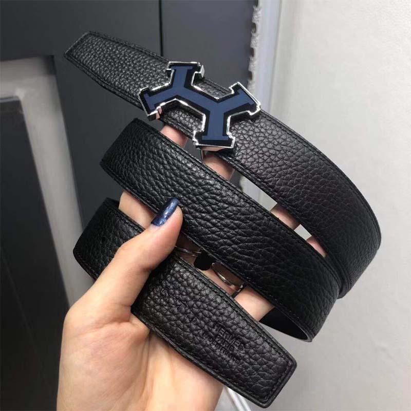 Close-up of polished H buckle on black reversible leather strap