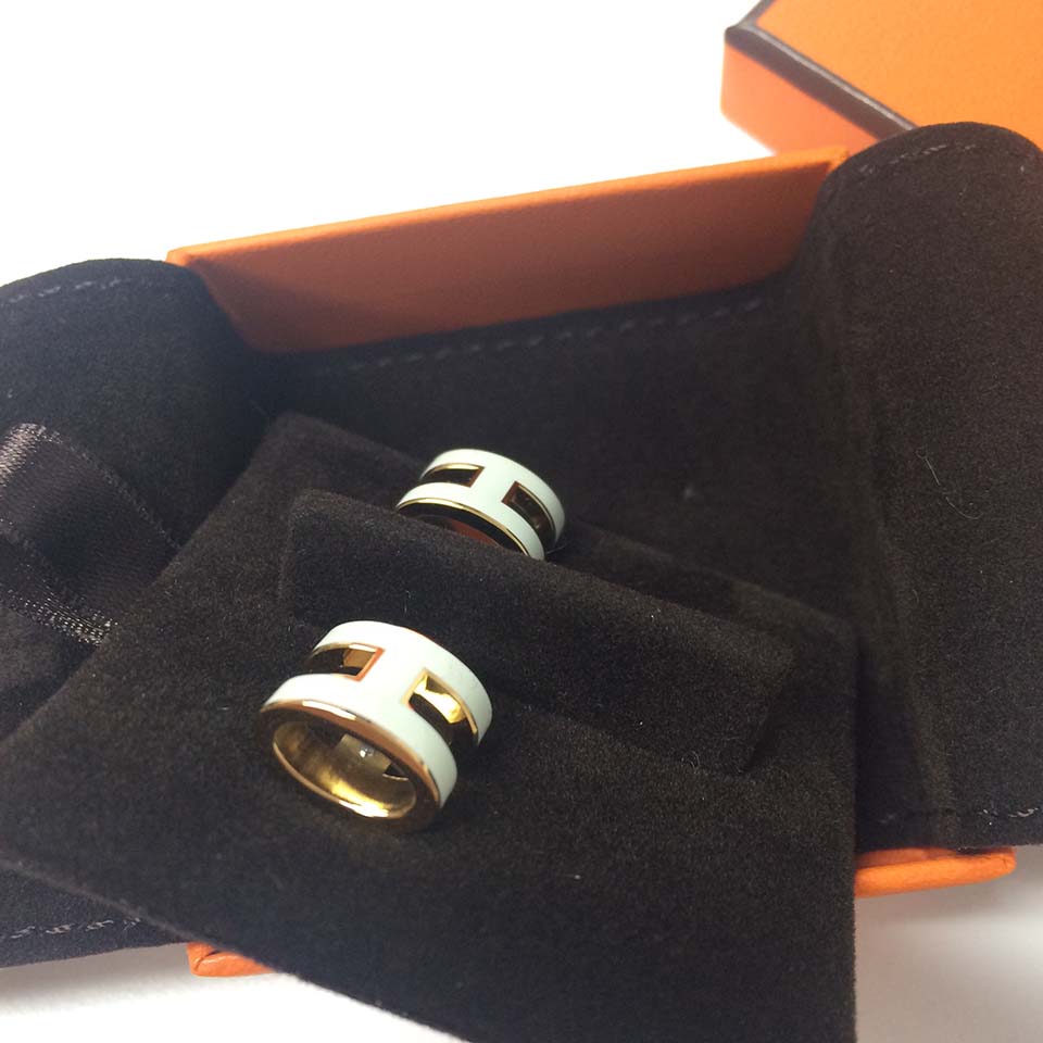 Close-up detail of Hermes Women Pop H Earrings Jewelry White clasp mechanism