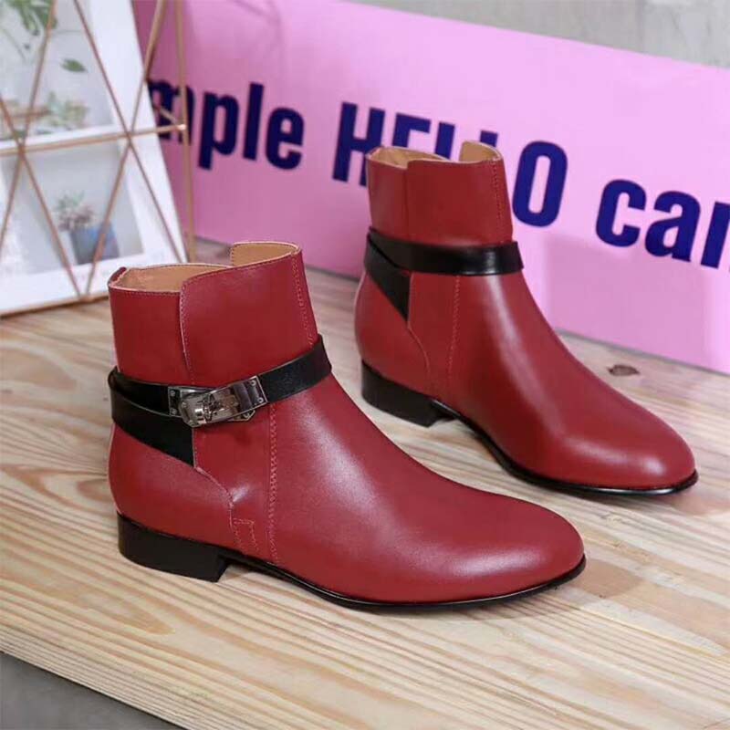 Close-up of Hermes silver hardware on maroon leather ankle boot