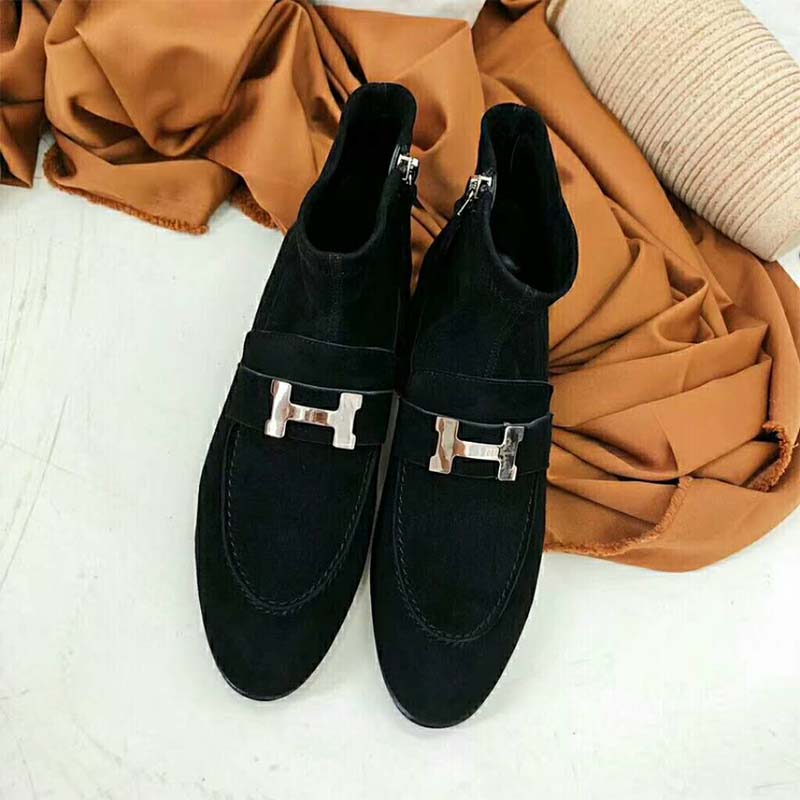Close-up of black leather and silver hardware on Hermes ankle boot