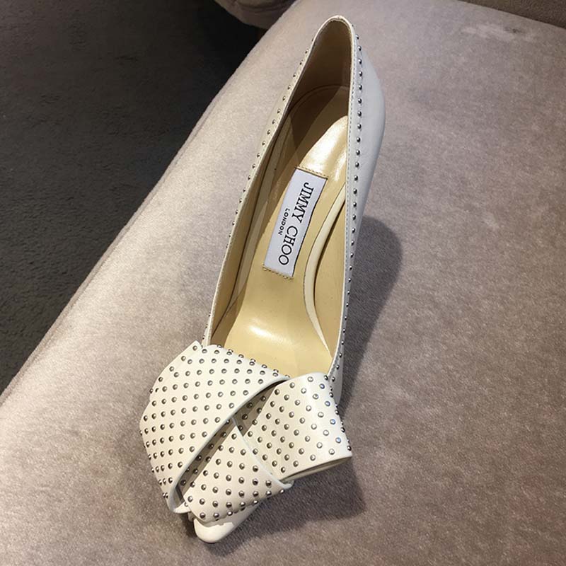 Close-up of studded bow detailing on Jimmy Choo Women Tegan 100 shoes