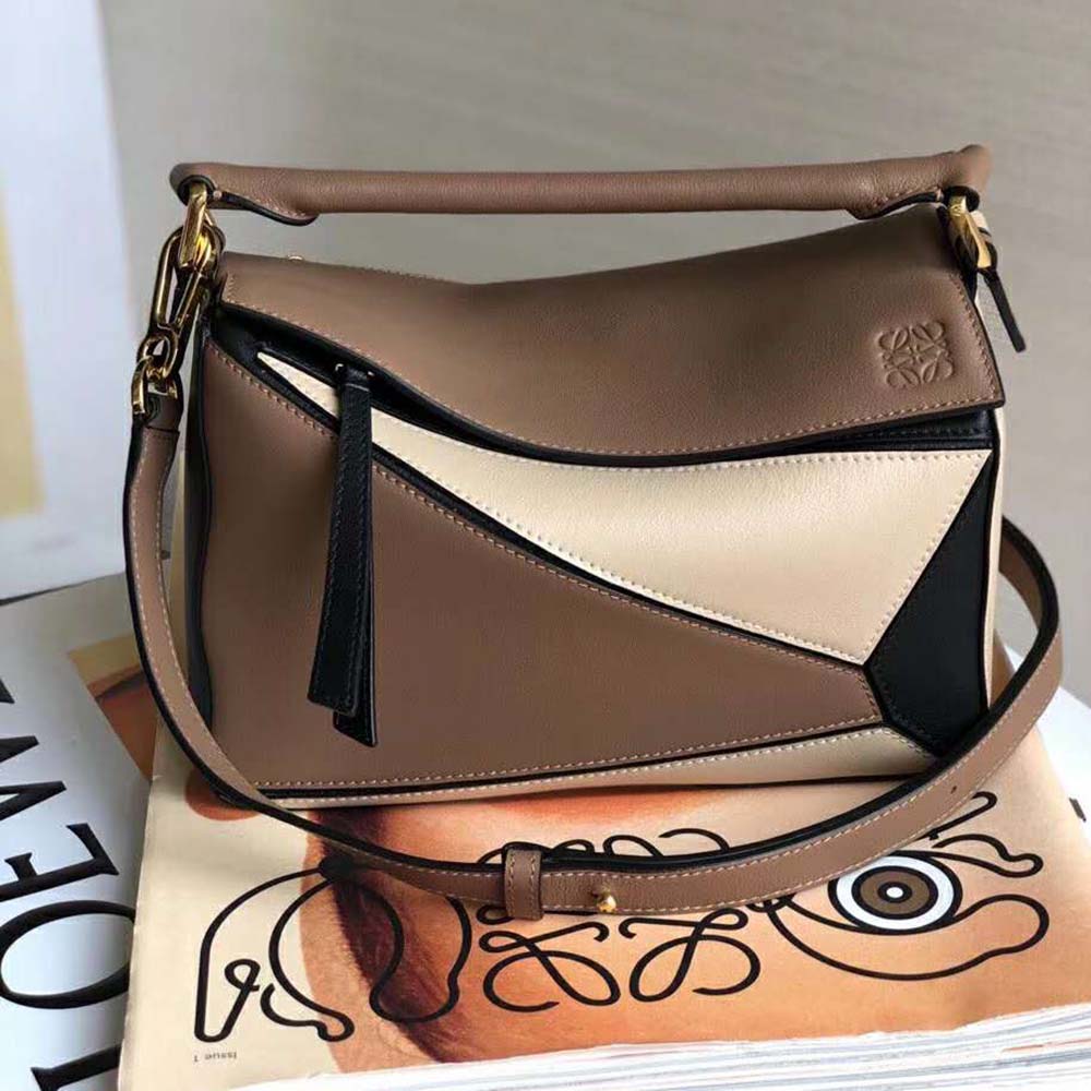 Close-up of brown leather texture and gold closure on Loewe Women Puzzle Bag