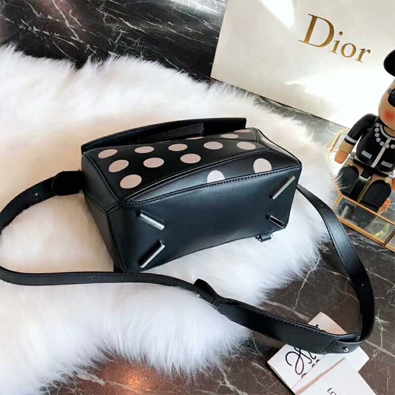 Side angle highlighting silhouette and shoulder strap on Loewe Women Puzzle Dots Bag Black/Greige
