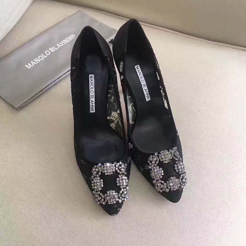 Overhead angle showing pointed toe and lace texture on black Hangisi pumps