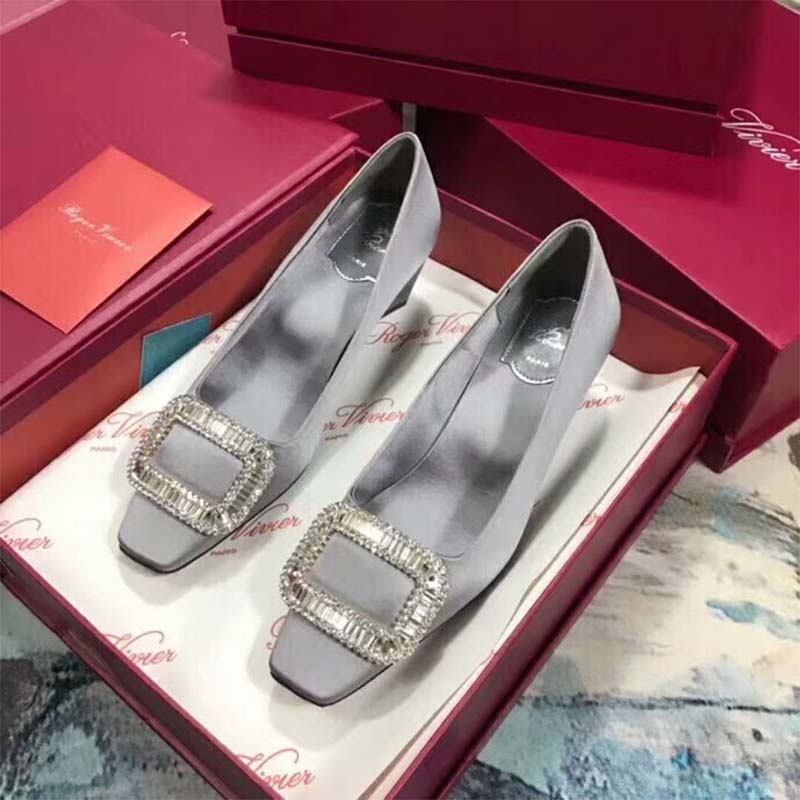 Close-up of signature square buckle on Belle Vivier Pumps silver satin