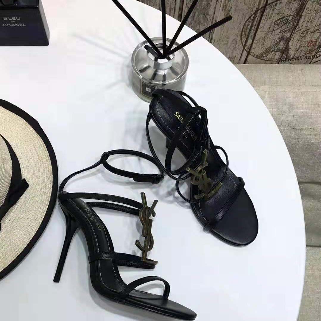 Close-up of black YSL logo detail on Cassandra Sandals heel