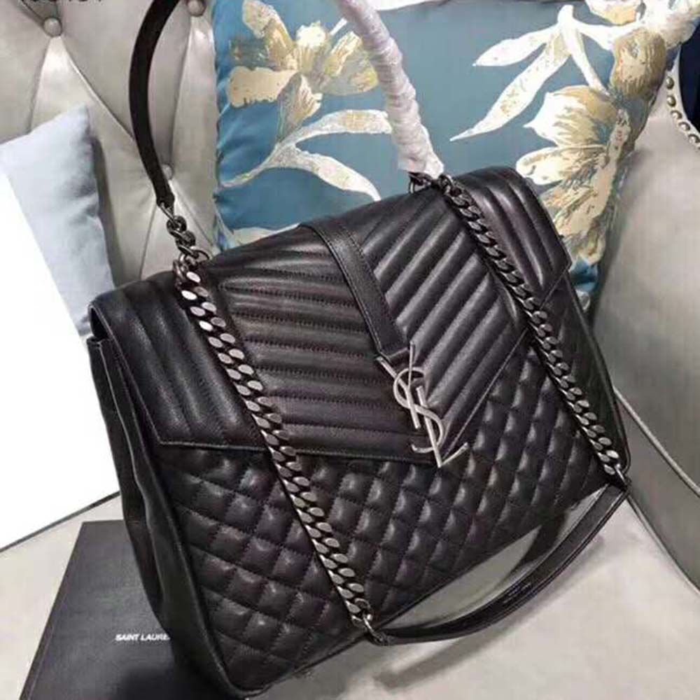 Close-up of gold YSL logo hardware on Black Large Envelope Matelasse bag