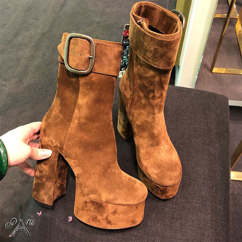 Close-up of gold YSL logo detail on brown suede Billy Platform Bootie
