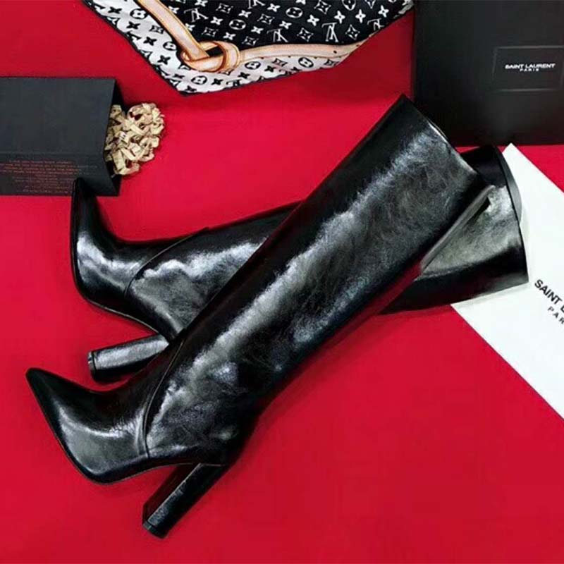 Close-up of Saint Laurent YSL logo hardware on Lou Boot heel