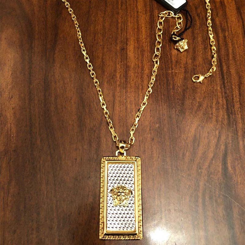 Side angle showing lobster clasp and chain texture on Versace necklace