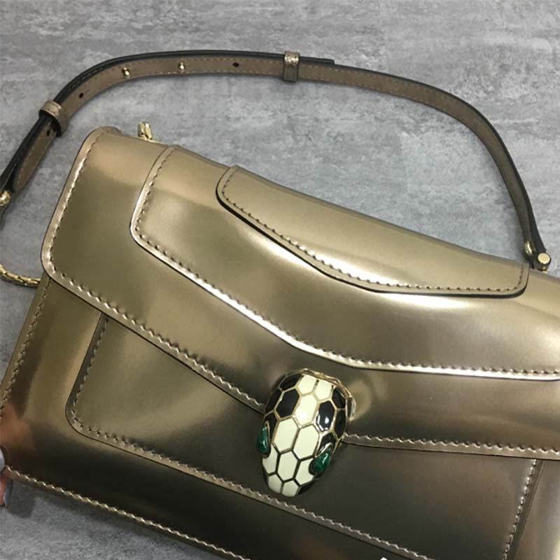 Close-up of gold serpent head clasp on Bvlgari Serpenti Forever bag