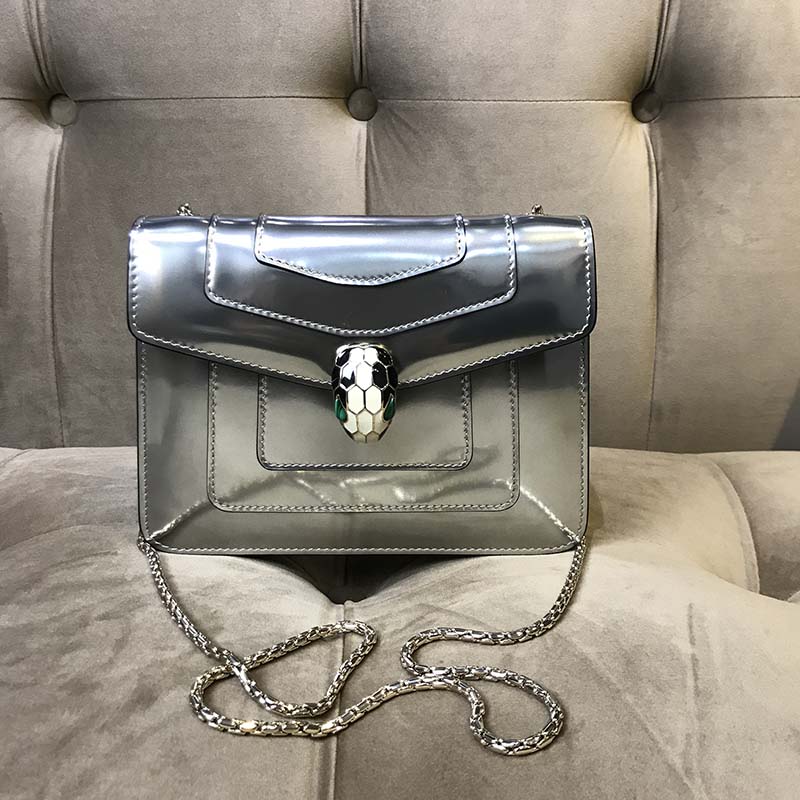 Close-up of silver serpent head clasp detail on Bvlgari Serpenti Forever bag