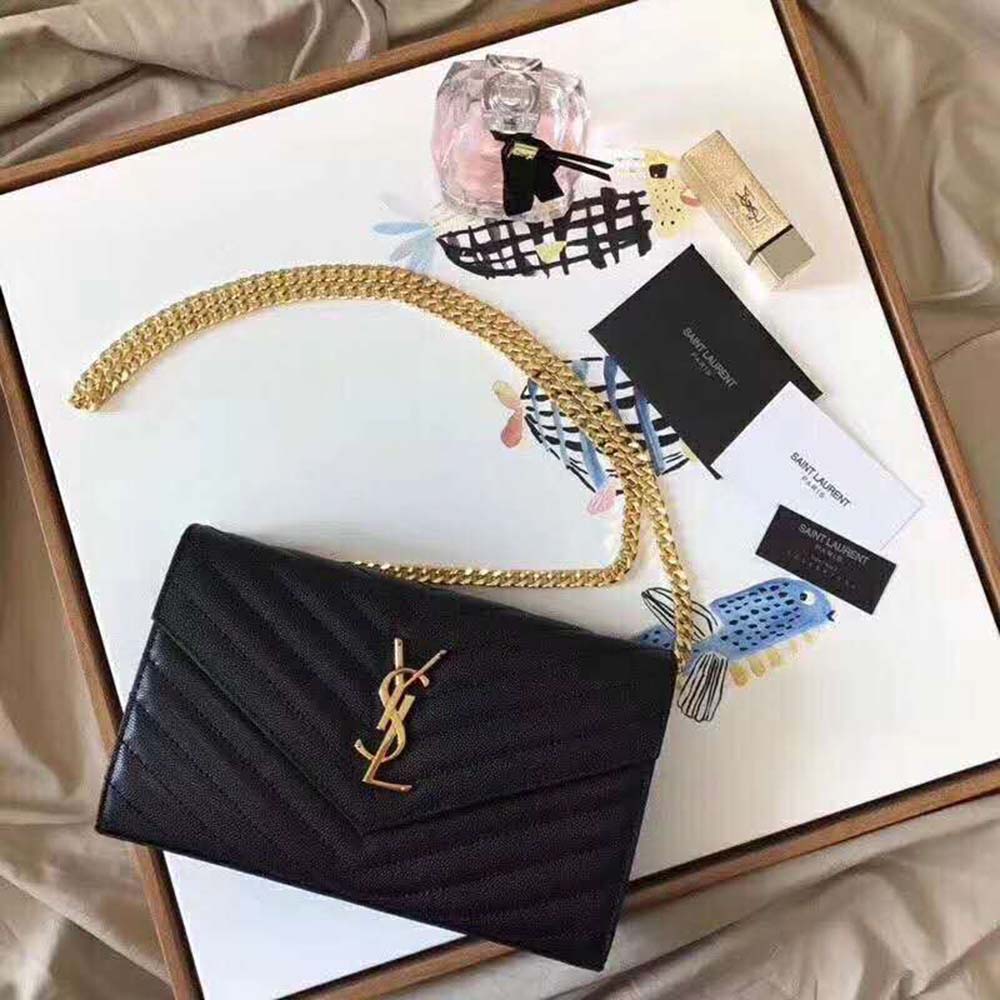 Close-up of gold YSL monogram hardware on Saint Laurent Monogram Chain Wallet