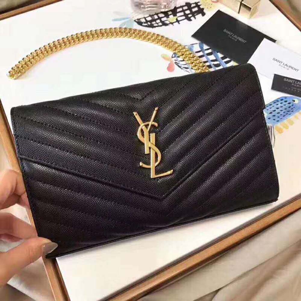 Side angle showing chain strap and embossed texture of Saint Laurent Monogram Chain Wallet