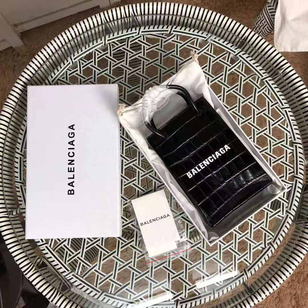 Close-up of crocodile embossing and silver Balenciaga hardware on phone holder
