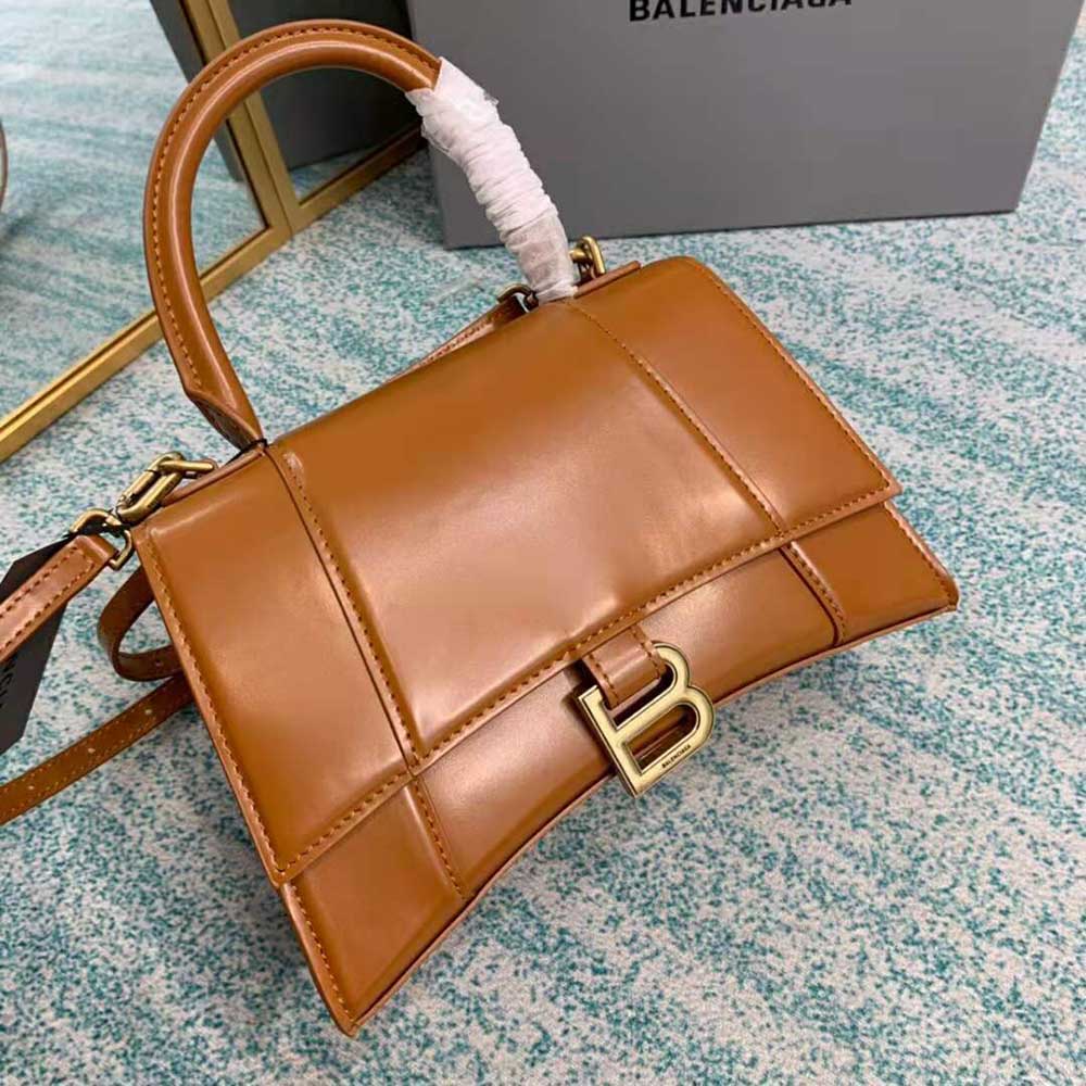 Side profile showing curved hourglass silhouette of Balenciaga Small Top Handle Bag
