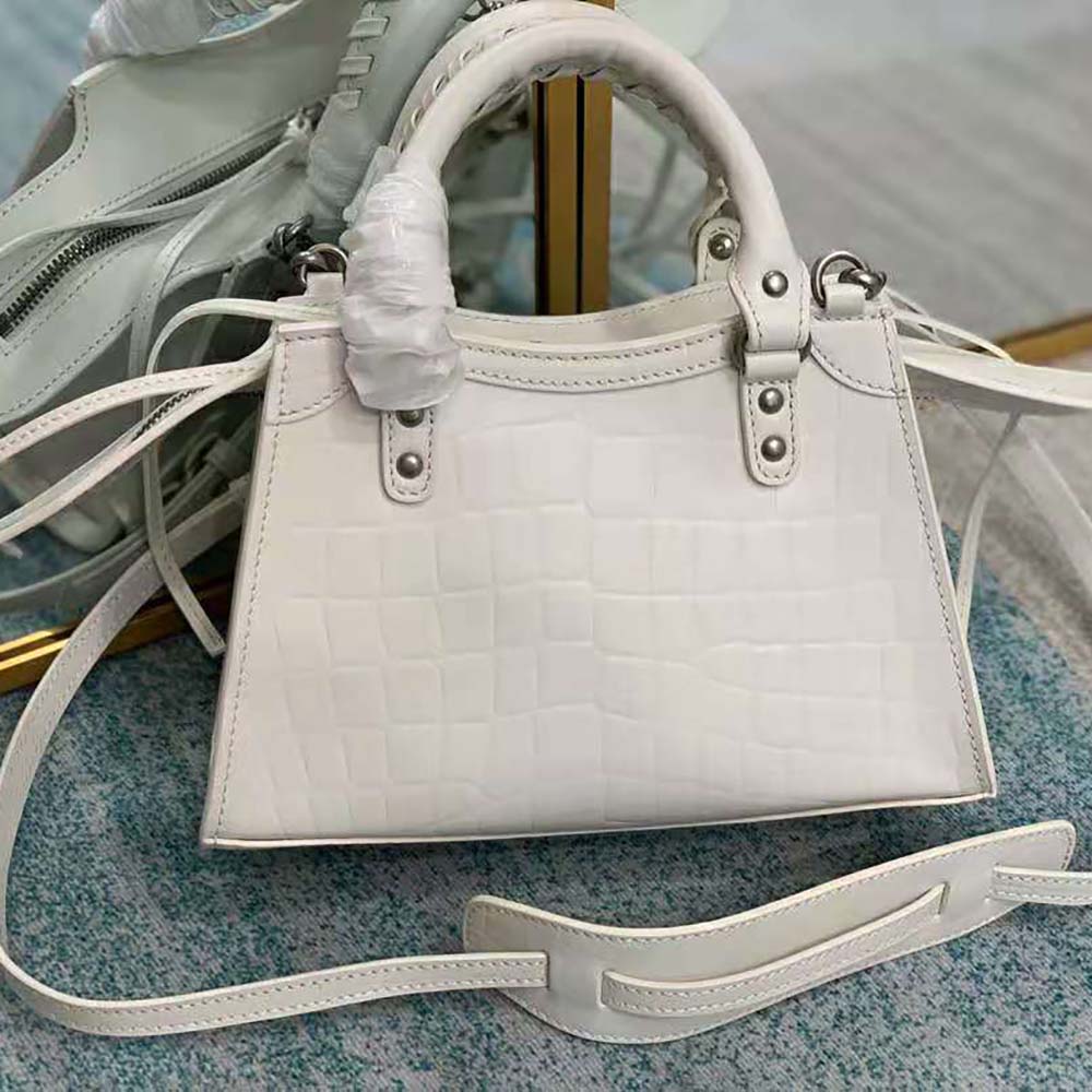 Side angle showing structured silhouette of Balenciaga Women Neo Classic Mini Top Handle Bag-White