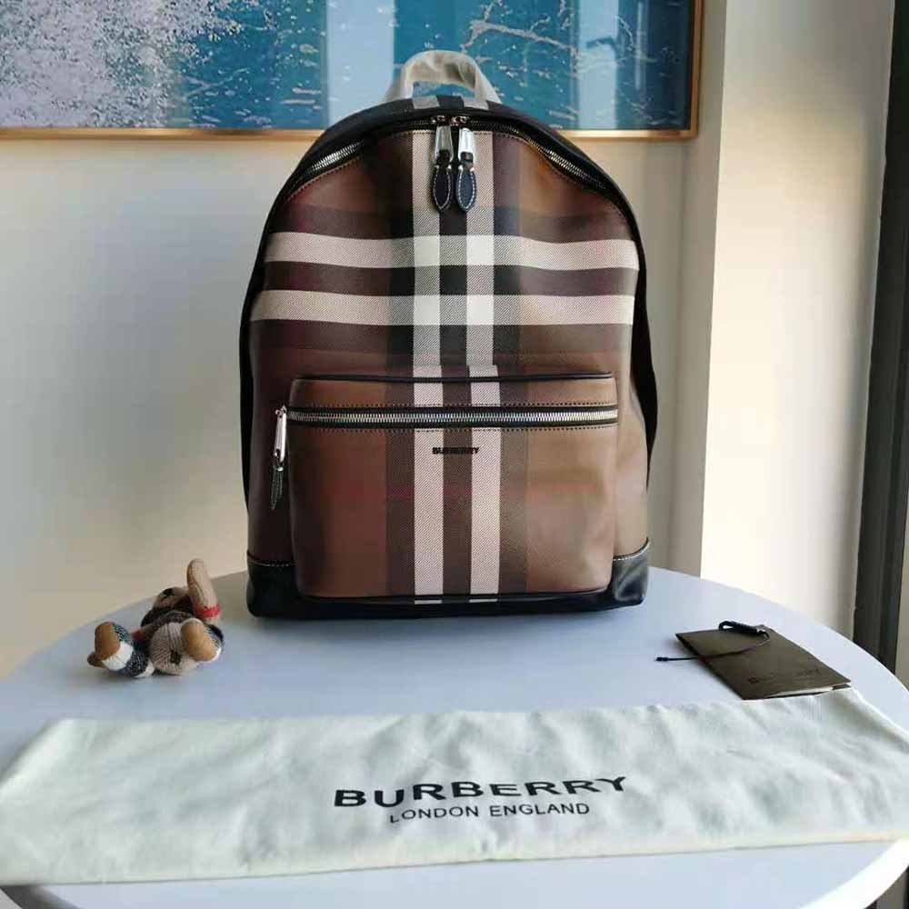 Close-up of brown leather trim and polished hardware on backpack